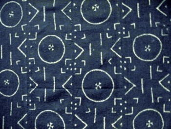 Contemporary African textile design used for a woman's skirt (Basiae Ba). The textile was created by Mignan Coulibaly in the Beledougou region, Bamana, Mali, c. 1987. This cotton garment includes hand painting, weaving and hand stitching as well as the use of natural dyes.