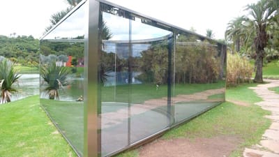 Graham’s famous <i>Pavillions</i>, like <i>Bisected Triangle Interior Curve</i> (2002), inspired other artists, like Daniel Buren and Yayoi Kusama, to combine sculpture, architecture, and installation art.